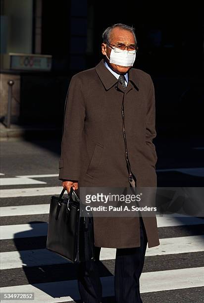 pedestrian wearing mask - overcoat stock pictures, royalty-free photos & images