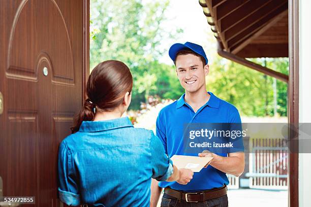 postman delivering a mail - answering door stock pictures, royalty-free photos & images