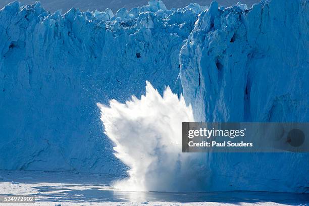 iceberg calving from eqip glacier on disko bay - sciogliere foto e immagini stock