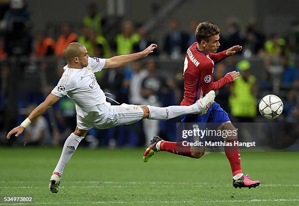 Pepe of Real Madrid stretches to stop the run of Antoine Griezmann of Atletico Madrid during the UEFA Champions League Final match between Real...