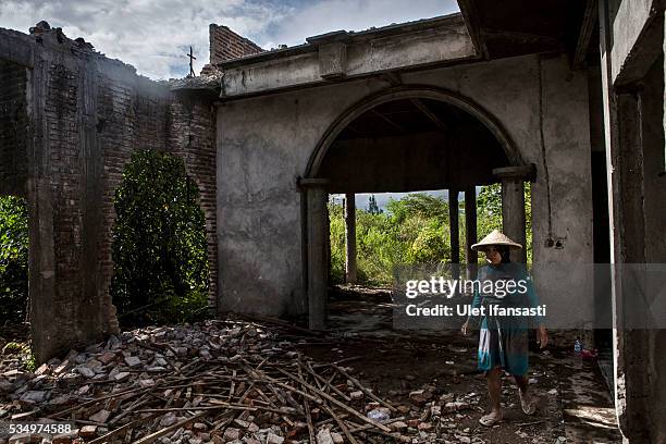Woman walks through the demolition on May 27, 2016 in Sidoarjo, East Java, Indonesia. On 29 May a mudflow eruption began in the Sidoarjo regency of...