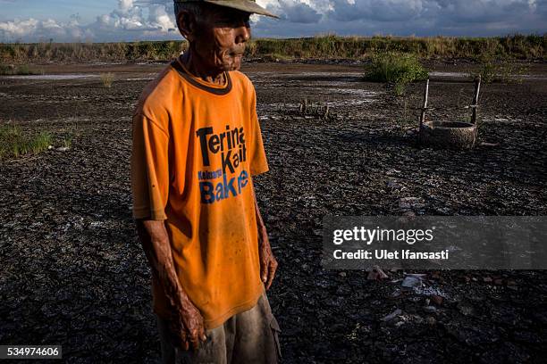 Suwadi , stands behind his house affected by mudflow on May 27, 2016 in Sidoarjo, East Java, Indonesia. On 29 May a mudflow eruption began in the...