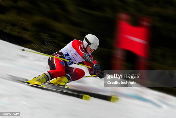 side view of young man at giant slalom competition - slalom stockfoto's en -beelden