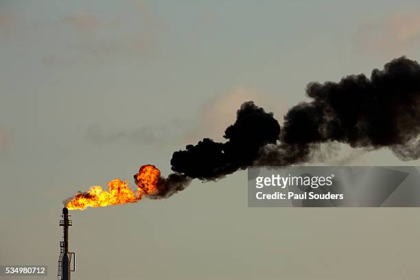 flames and smoke billow from natural gas flare at valero oil refinery - oil refinery stock pictures, royalty-free photos & images