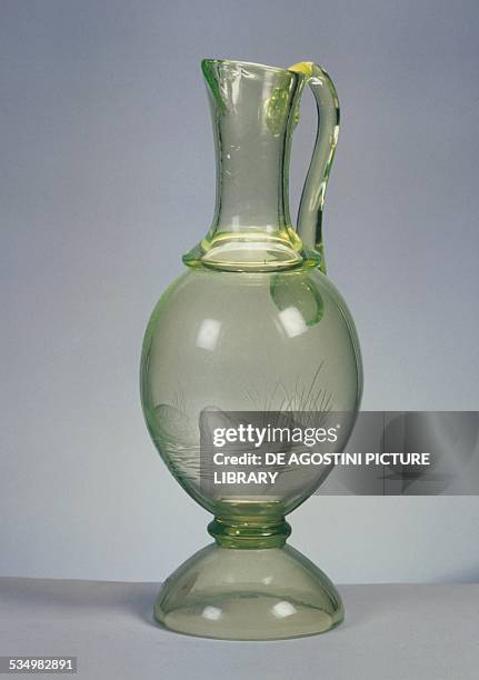 Swan carafe in yellow uranium blown glass standing on an inverted cup-shaped base, made by SAV . Italy, 20th century. Altare, Museo Del Vetro E...