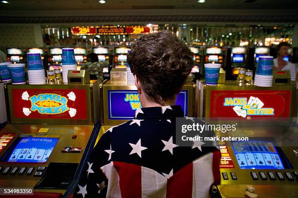 Women plays a poker machine at Harrah's Casino in Las Vegas.