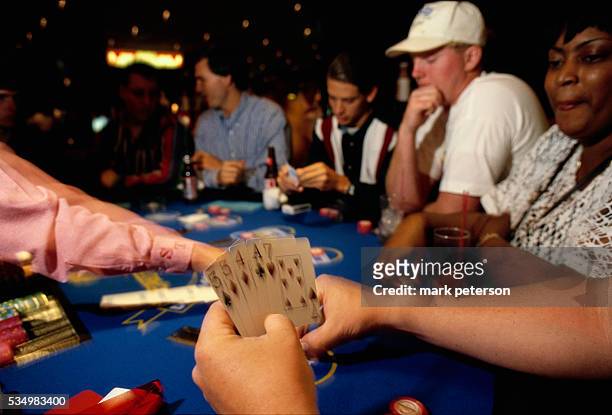 Card dealer deals cards to gamblers during a game of poker in Mississippi.