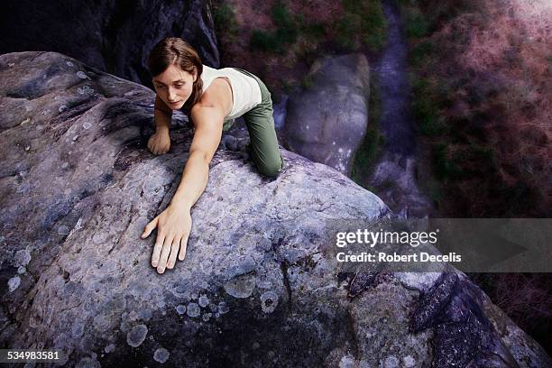 female free climber reaching forward with arm - freiklettern stock-fotos und bilder