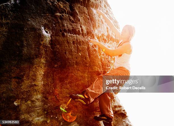 female free climber ascending boulder - soloing stock pictures, royalty-free photos & images