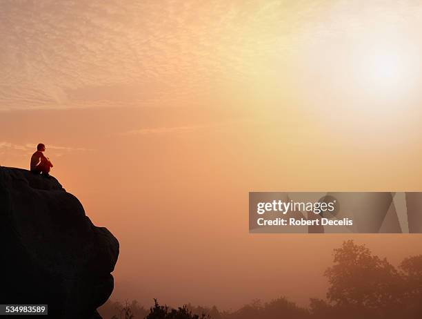 female free climber seated at top of rock - women in harmony stock pictures, royalty-free photos & images