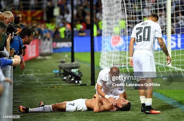 Cristiano Ronaldo of Real Madrid celebrates with team mate Pepe of Real Madrid anf Jese of Real Madrid after scoring the winning penalty during the...