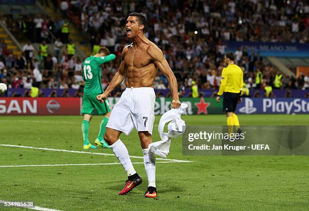 Cristiano Ronaldo of Real Madrid celebrates after scoring the winning penalty in the penalty shootout during the UEFA Champions League Final between...