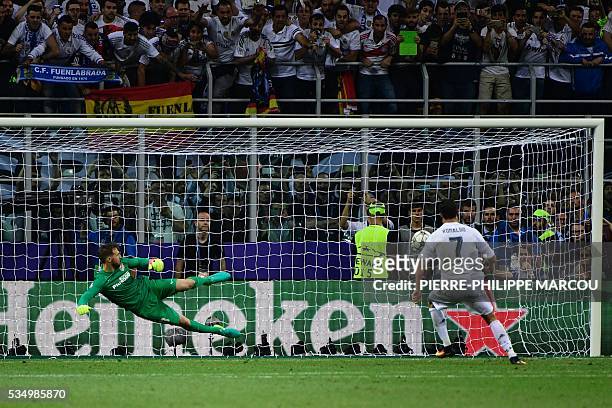 Real Madrid's Portuguese forward Cristiano Ronaldo kicks to score during the penalty shoot-out in the UEFA Champions League final football match...