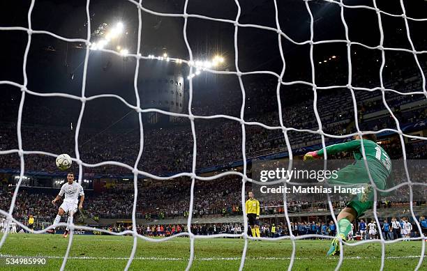 Cristiano Ronaldo of Real Madrid scores the winning penalty past Jan Oblak of Atletico Madrid during the UEFA Champions League Final match between...