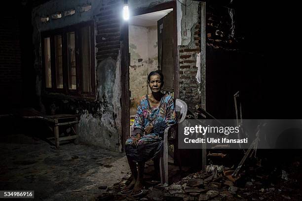 Senima , sits in front of her house which was affected by mudflow in Merisen Village on May 27, 2016 in Sidoarjo, East Java, Indonesia. The Merisen...