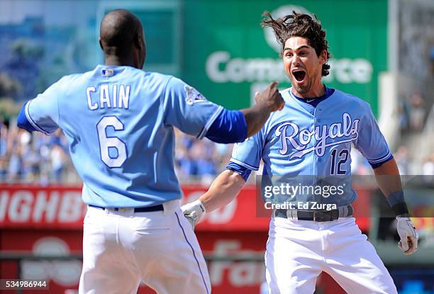 Brett Eibner of the Kansas City Royals celebrates his game-winning RBI single with Lorenzo Cain of the Kansas City Royals in the ninth inning against...