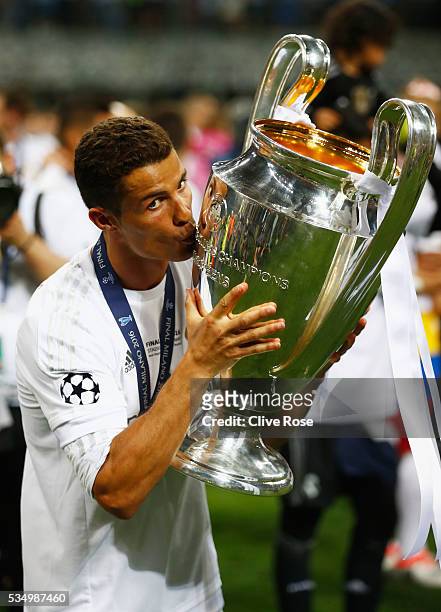 Cristiano Ronaldo of Real Madrid kisses the Champions League trophy after the UEFA Champions League Final match between Real Madrid and Club Atletico...