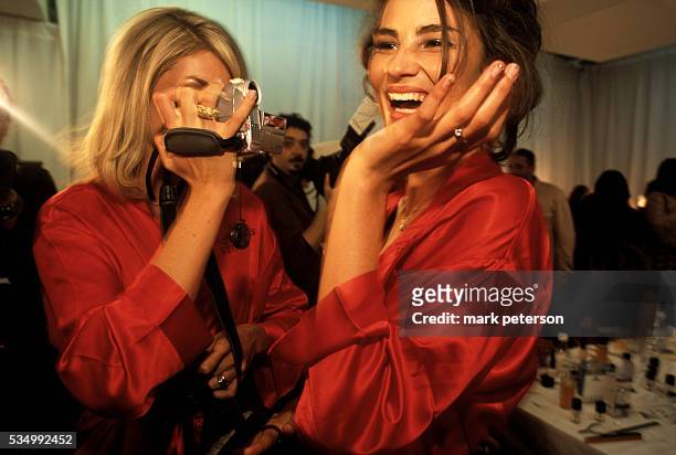Models Ana Hickman and Caroline Ribeiro have a fun moment backstage prior to the 8th Annual Victoria's Secret Fashion Show. --- Photo by Mark...