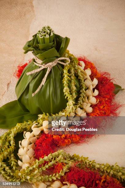 flower leis and banana leaf bundle - hawaii souvenir stock pictures, royalty-free photos & images