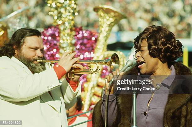 Ella Fitzgerald sings while Al Hirt plays the trumpet during the half-time show at the Superbowl.