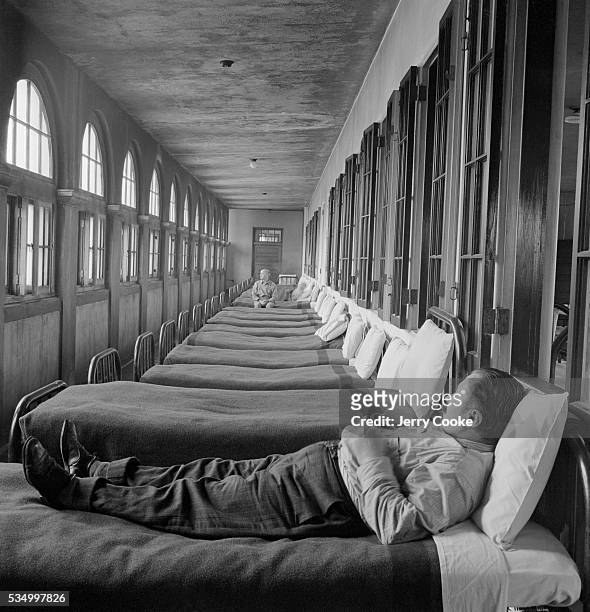 Psychiatric Patient in Asylum Sleeping Area