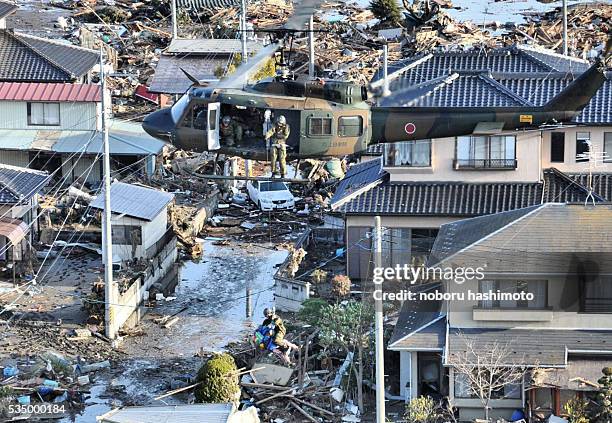 March 15,2011/Noboru Hashimoto/Tokyo/Japan Mega eartquake disaster in Northern Japan.The self-defense force helicopter lifts a victim in Watari-town...
