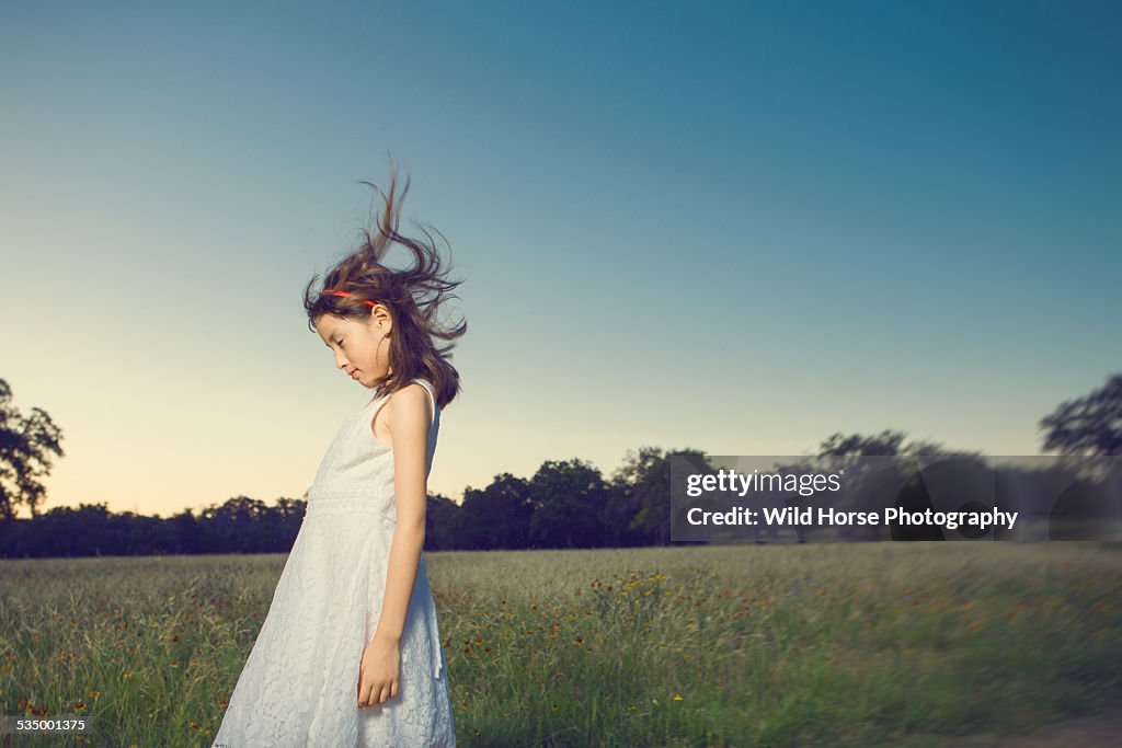 Girl fells wind in the field