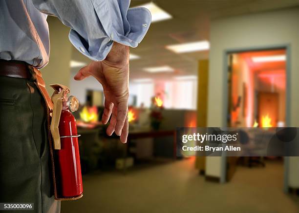 businessman extinguishing office fire - impianti antincendio foto e immagini stock