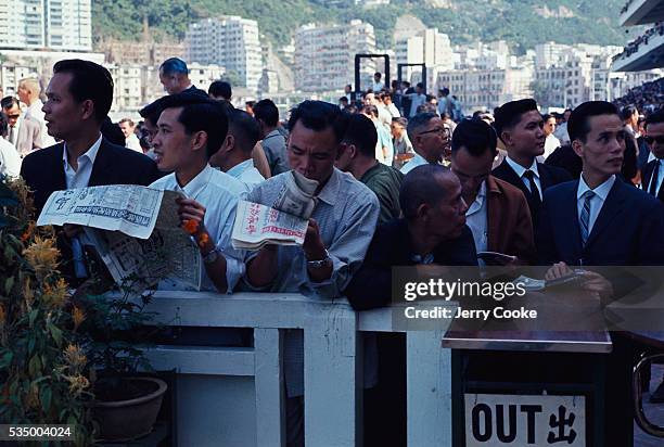 Men check over the odds at the Happy Valley Racecourse.