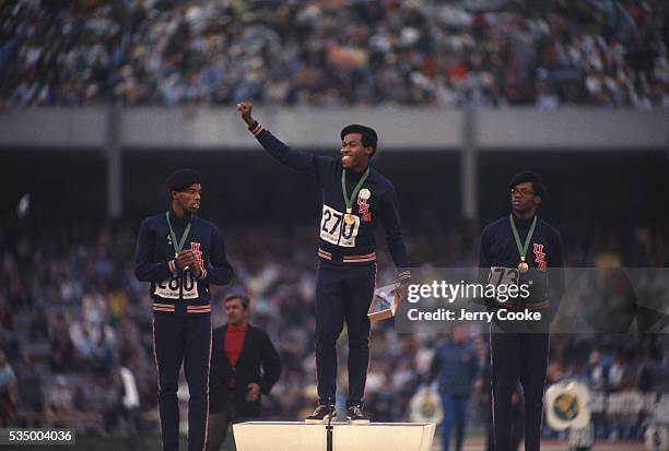 American sprinters Larry James, Lee Evans and Ronald Freeman III stand on the winner's podium at the 1968 Olympic games in Mexico City. The three men...