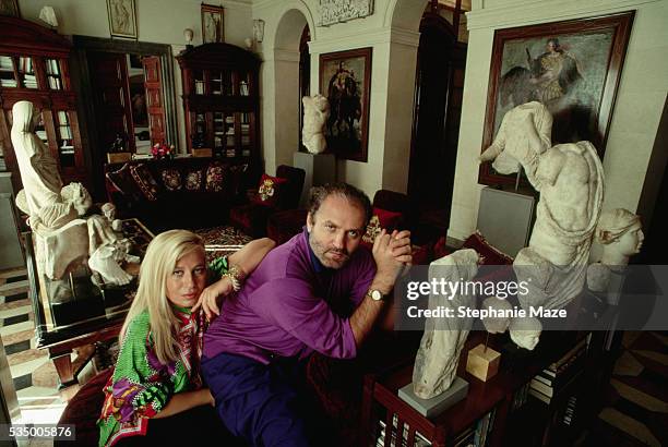 Fashion designer Donatella Versace and her brother Gianni sit among the artworks they have collected in their home in Milan.
