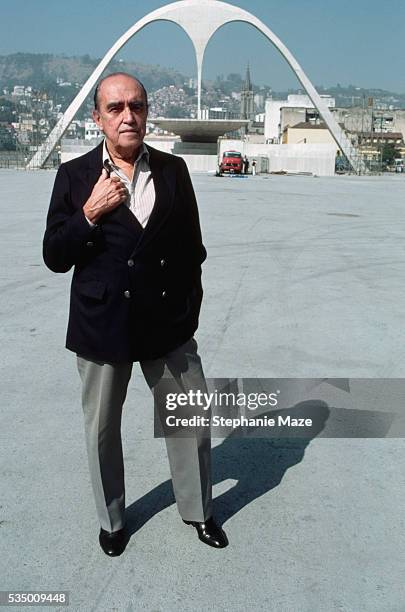 Brazilian architect Oscar Niemeyer standing in front of the Apoteose do Sambodromo, under construction in Rio de Janeiro, Brazil, circa 1984.