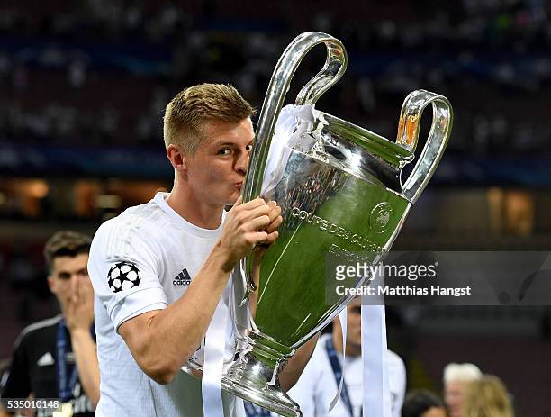 Toni Kroos of Real Madrid kisses the Champions League trophy after the UEFA Champions League Final match between Real Madrid and Club Atletico de...