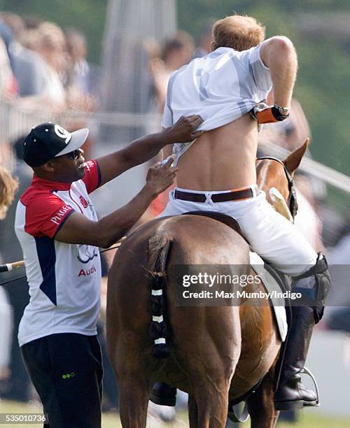 Prince Harry receives treatment to his back as he takes part in the Audi Polo Challenge at Coworth Park Polo Club on May 28, 2016 in Ascot, England.