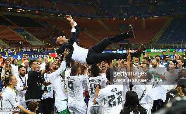 Zinedine Zidane manager of Real Madrid is thrown in the air by the players after the UEFA Champions League Final between Real Madrid and Club...