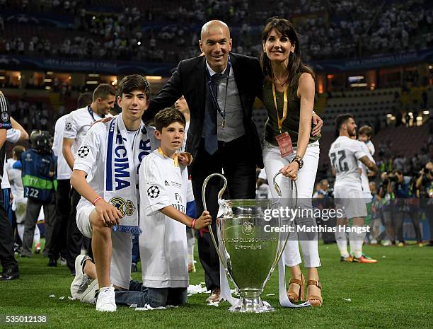 Real Madrid head coach Zinedine Zidane poses with the trophy and his family after winning the UEFA Champions League Final match between Real Madrid...