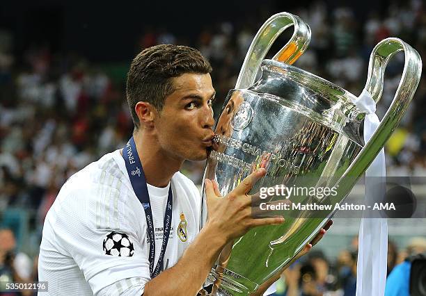 Cristiano Ronaldo of Real Madrid kisses the trophy following his team's victory in a penalty shootout during the UEFA Champions League final match...