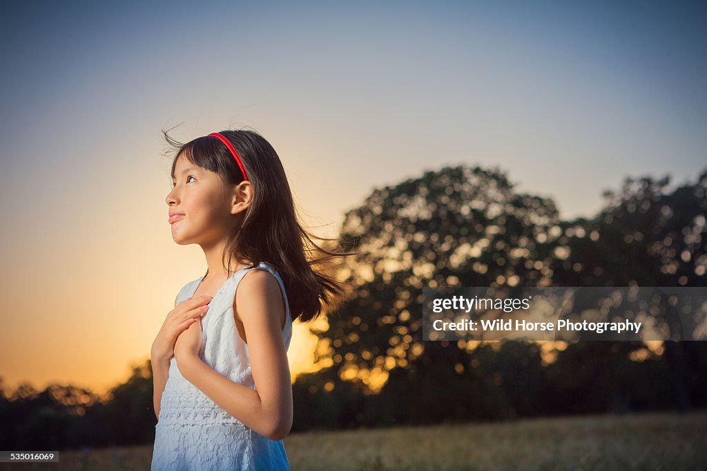 Girl looking away in sunset