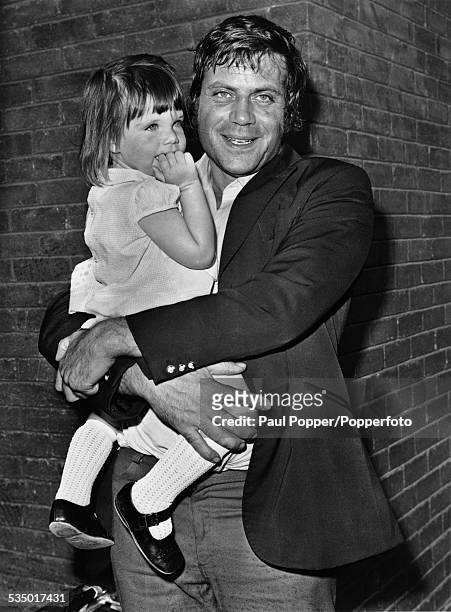 English actor Oliver Reed with his two year-old daughter Sarah, London, 3rd August 1971.