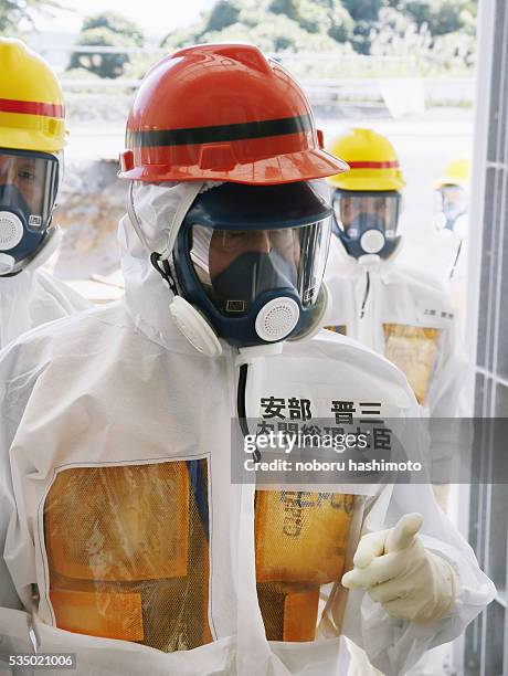 Japanese Prime Minister Shinzo Abe arrives at a facility of water treatment equipment called advanced liquid processing system during his inspection...