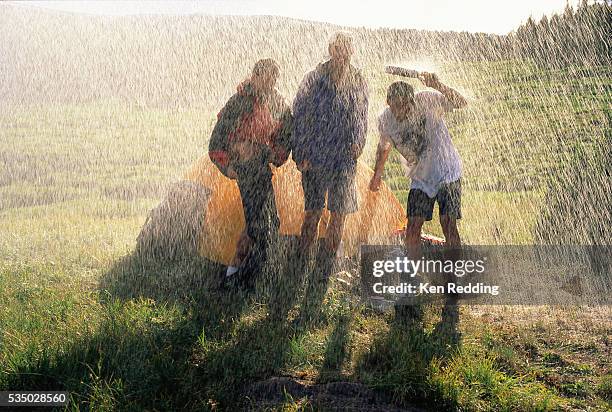 campers caught in a downpour - shower stock pictures, royalty-free photos & images