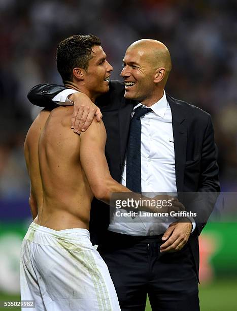 Real Madrid head coach Zinedine Zidane hugs a smiling Cristiano Ronaldo of Real Madrid after the UEFA Champions League Final match between Real...
