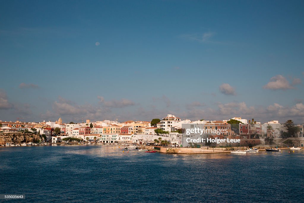 Es Castell on Mahon harbor with full moon