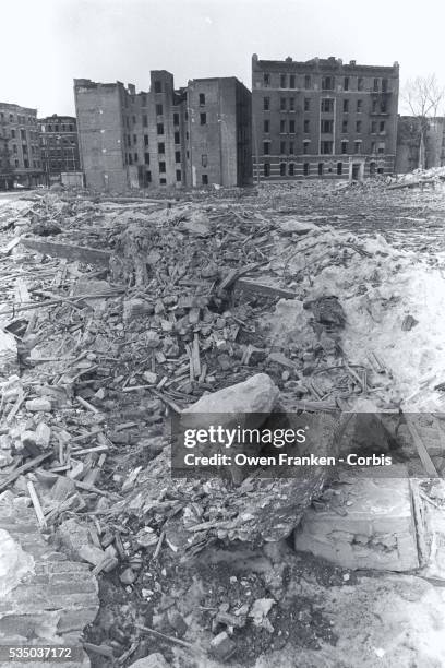 Abandoned apartment houses surround a vacant lot covered with rubble in the Bronx.