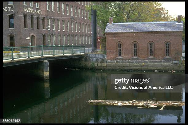 Old textile factory buildings on the river in Lowell, Massachusetts, 1988.
