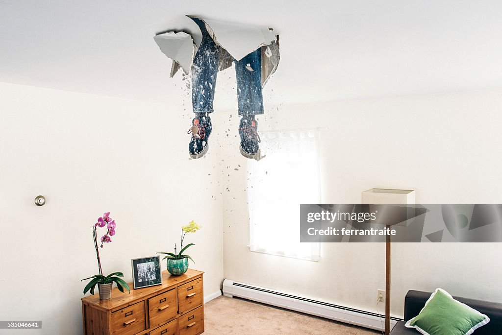 Man breaks ceiling drywall while doing DIY