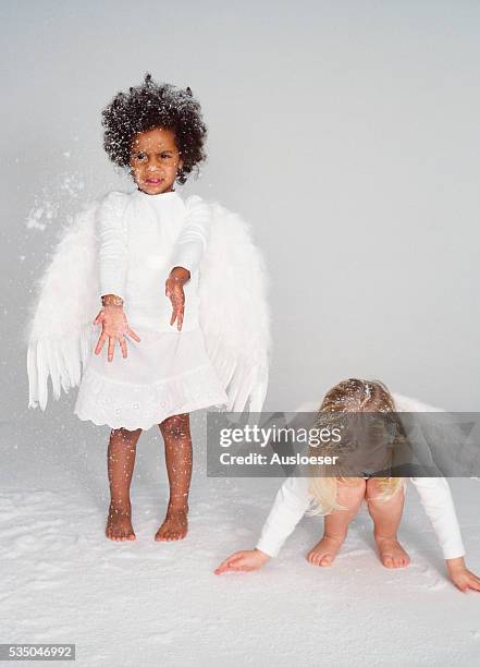 two girls with angel wings - barefoot snow stock pictures, royalty-free photos & images