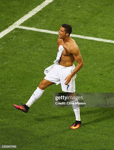 Cristiano Ronaldo of Real Madrid takes off his shirt in celebration after scoring the winning penalty in the penalty shoot out during the UEFA...