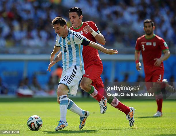 Lionel Messi of Argentina and Javad Nekounam of Iran
