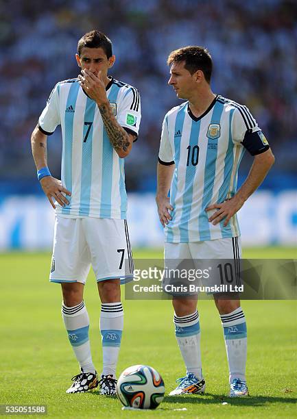 Lionel Messi of Argentina next to team-mate Angel Di Maria